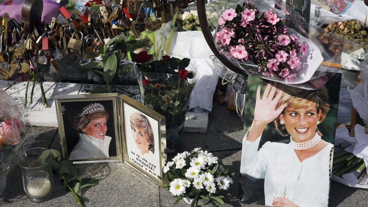 Iconic photos, flowers and messages dedicated to pay homage to Lady Diana to the 20th anniversary of her death adorn the plinth of the Flame of Liberty statue on Aug.31, 2017 in Paris.