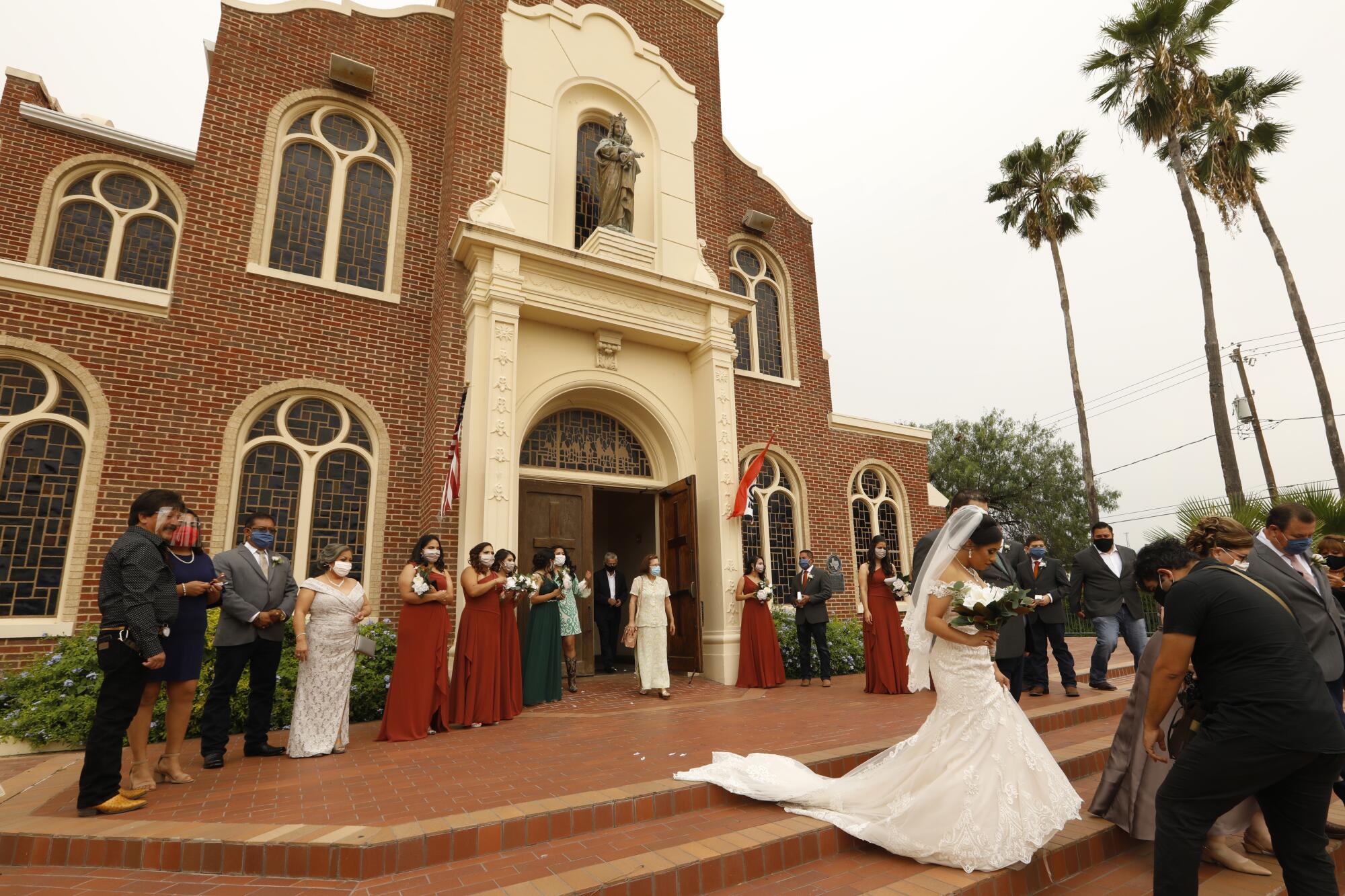 Masked guests attend a wedding at Our Lady of Guadalupe Catholic Church in Mission, Texas.