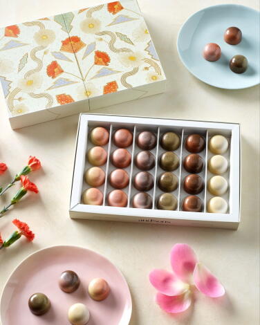 Chocolates in a collectible box with poppies.