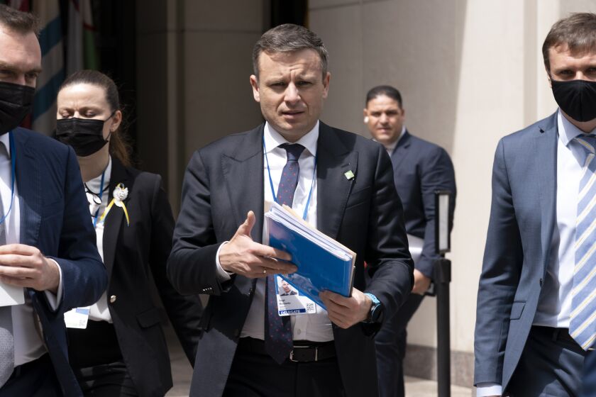 FILE - Ukraine Finance Minister Serhiy Marchenko walks outside of the International Monetary Fund (IMF) building during the World Bank/IMF Spring Meetings in Washington, on April 21, 2022. Ukraine's finance minister says crucial Western financial aid is “not charity” but “self-preservation" as donor countries share the price of turning back Russian aggression. Marchenko told The Associated Press in an interview Thursday, Dec. 8 that his country is protecting freedom and democracy far beyond its borders. (AP Photo/Jose Luis Magana, File)