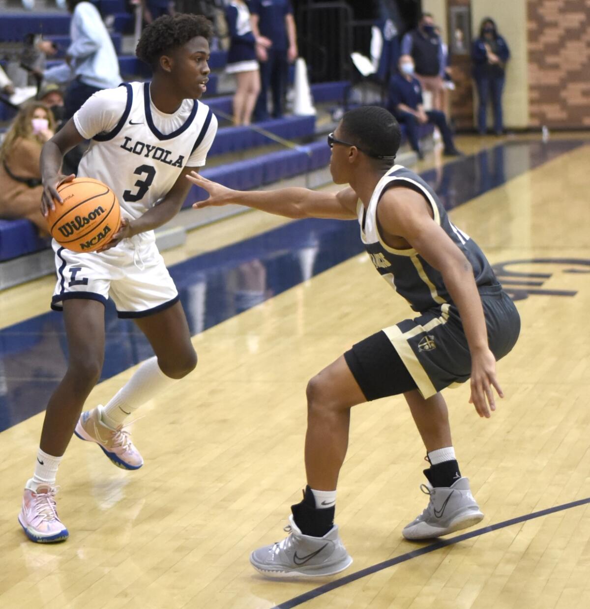 Loyola's Jalen Cox (left) goes against St. Francis' Jackson Mosley.