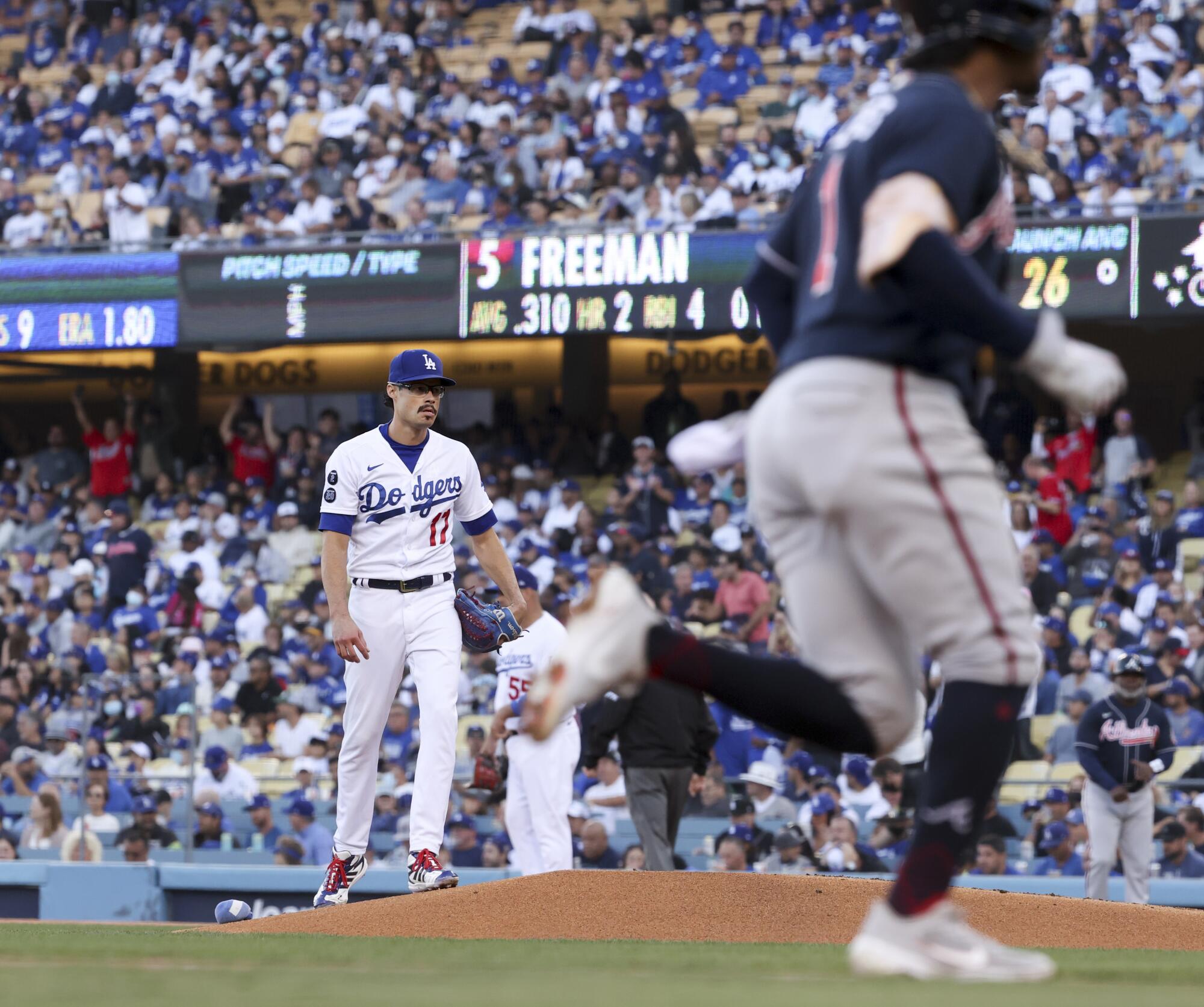  Dodgers starting pitcher Joe Kelly reacts as Atlanta Braves' Ozzie Albies rounds the bases.