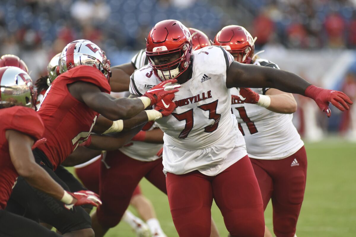 Louisville offensive lineman Mehki Becton (73) throws some blocks during a game against Western Kentucky on Sept. 14.
