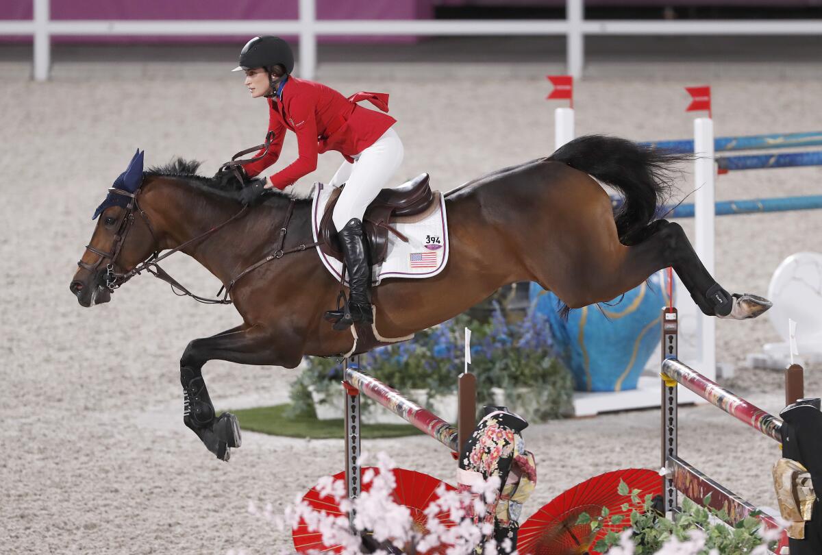 Jessica Springsteen's horse leaps over a bar.