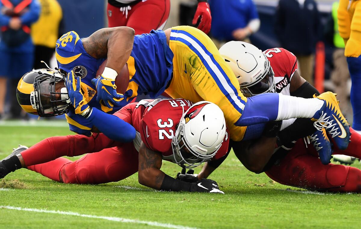 LOS ANGELES, CALIFORNIA DECEMBER 29, 2019-RAms running back Todd Gurley is stopped short of the goal line by Cardinal defenders Budda Baker (32) and Patrick Peterson in the 2nd quarter at the Coliseum Sunday. (Wally Skalij/Los Angerles Times)