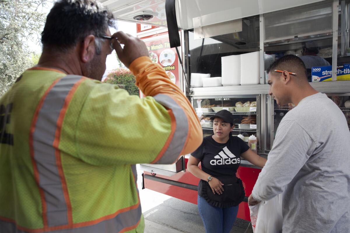 Jennifer Ramirez, 20, serves workers out of her food truck in Bel Air, Calif.