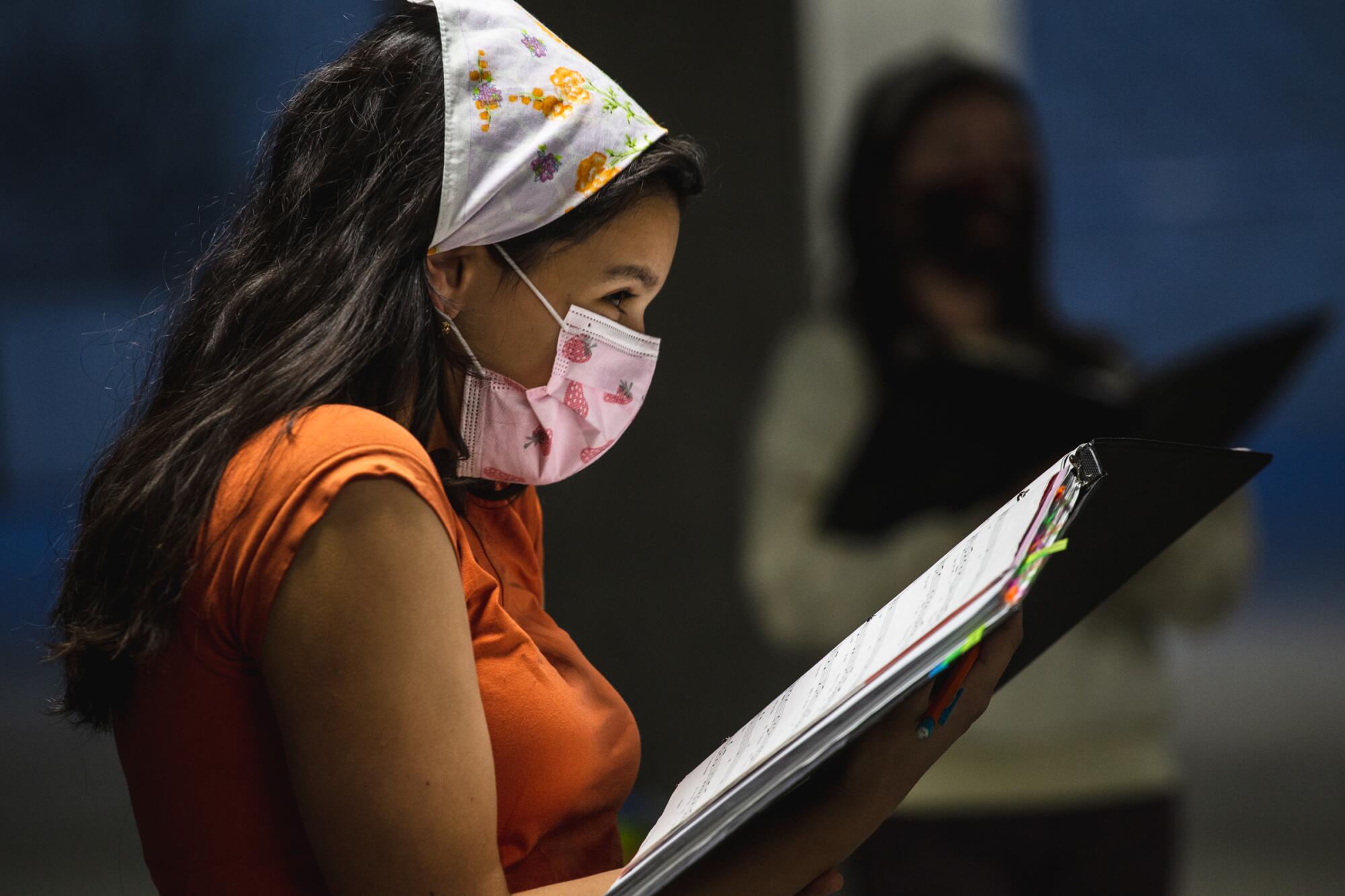 Vishaala Wilkinson laughs during rehearsal with San Diego Children’s Choir in a parking garage