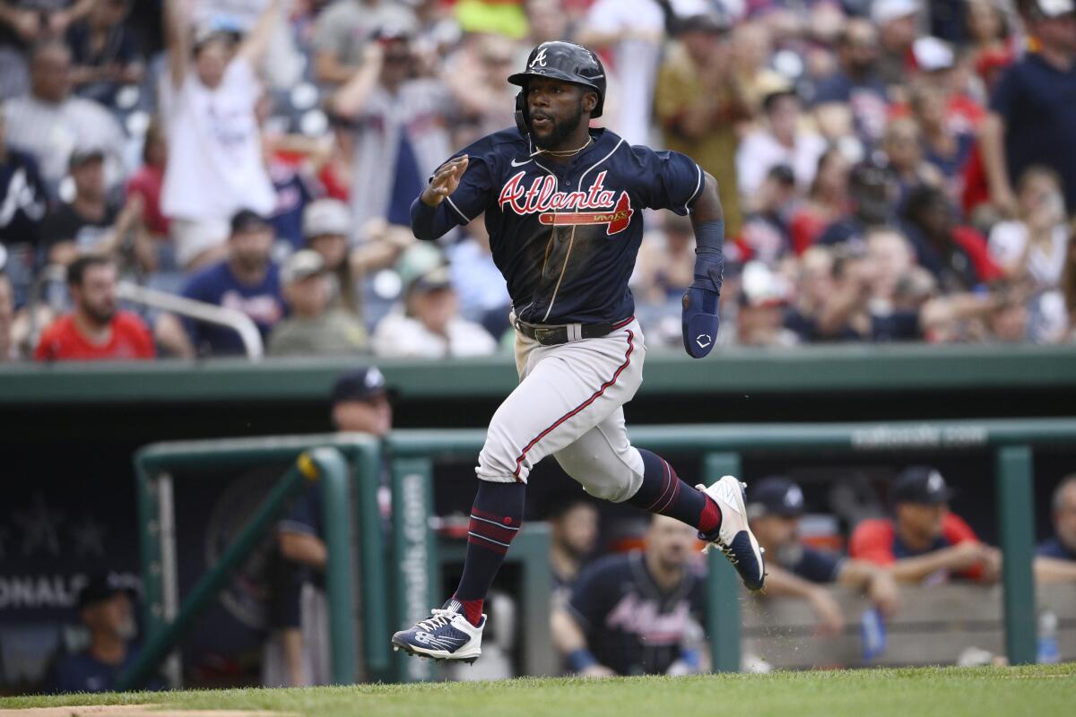 Atlanta Braves' Michael Harris II runs home to score on a double by Dansby Swanson during the seventh inning of a baseball game against the Washington Nationals, Saturday, July 16, 2022, in Washington. (AP Photo/Nick Wass)