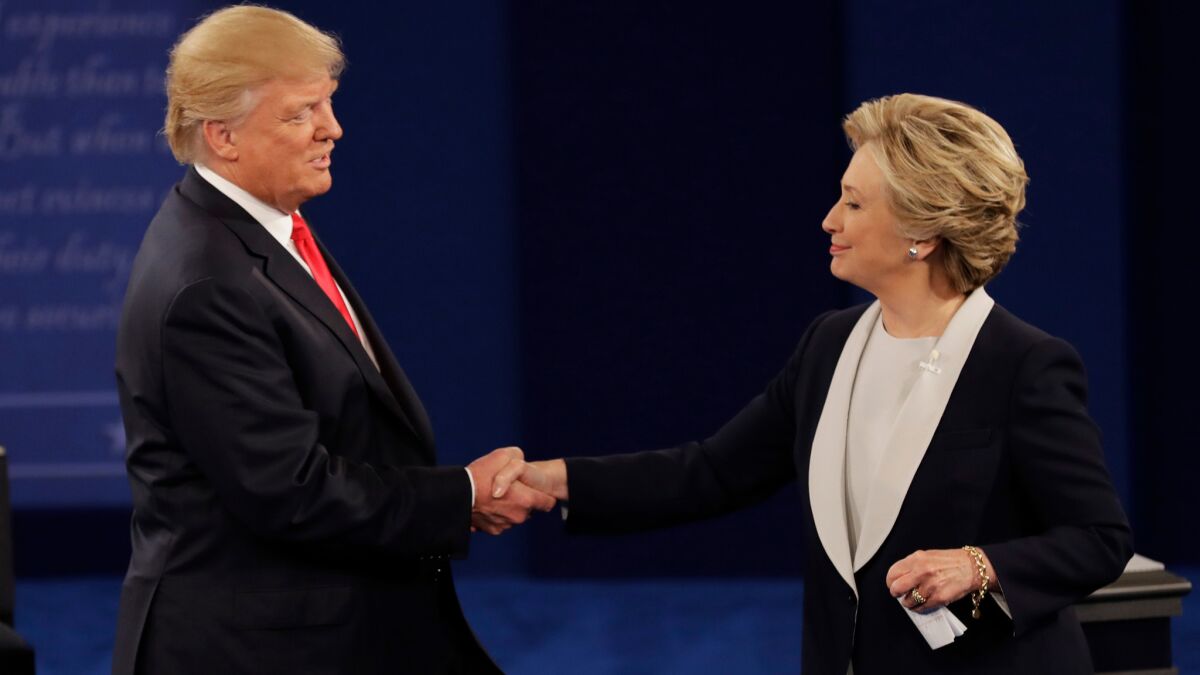 Republican nominee Donald Trump and Democratic nominee Hillary Clinton shake hands after Sunday's presidential debate in St. Louis.