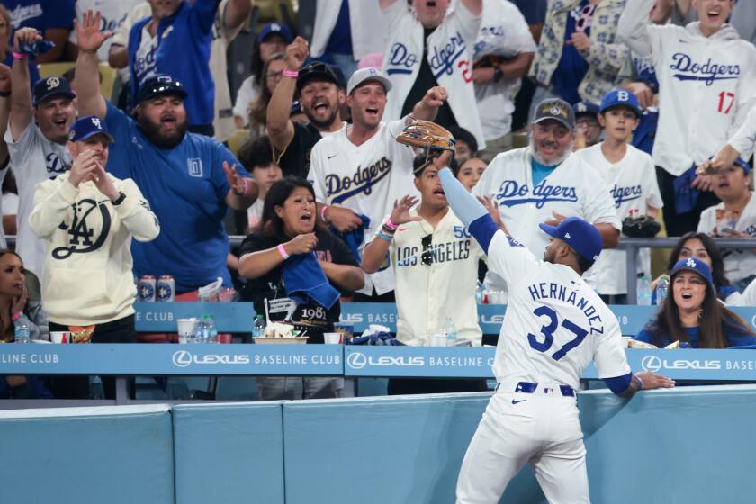 LOS ANGELES, CALIFORNIA - OCTOBER 13: Fans react after Teoscar Hernandez #37 of the Los Angeles Dodgers catches a fly ball by Brandon Nimmo #9 of the New York Mets during the sixth inning in game one of the National League Championship Series at Dodger Stadium on Sunday, Oct. 13, 2024 in Los Angeles. (Wally Skalij / Los Angeles Times)