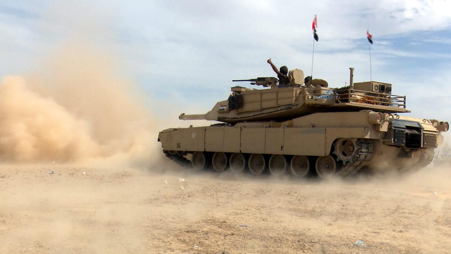 An Iraqi army tank advances in Tikrit on Tuesday during fighting with Islamic State militants.