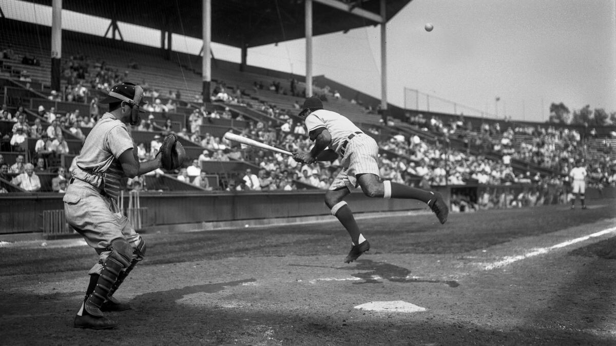 Aug. 26, 1950: Hollywood Stars' infielder Jim Baxes gets plunked in the back by a pitch from the San Francisco Seals' Chet Johnson during eighth-inning action at Gilmore Stadium. The Seals won 13-3. The Seals' catcher is Ray Orteig.
