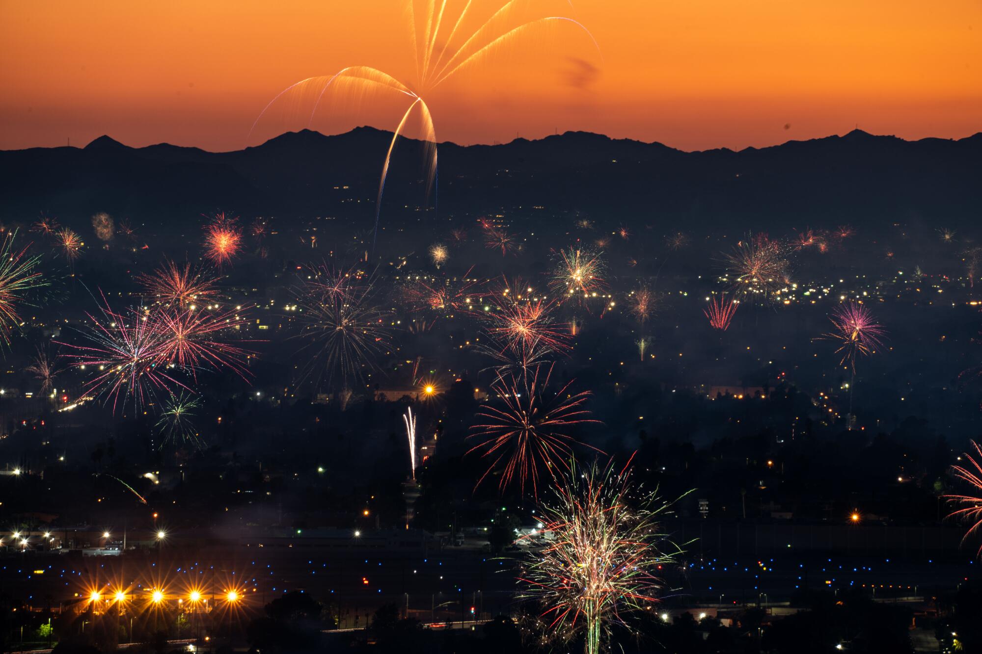 Fireworks light up the sky over North Hollywood, as seen from Burbank.