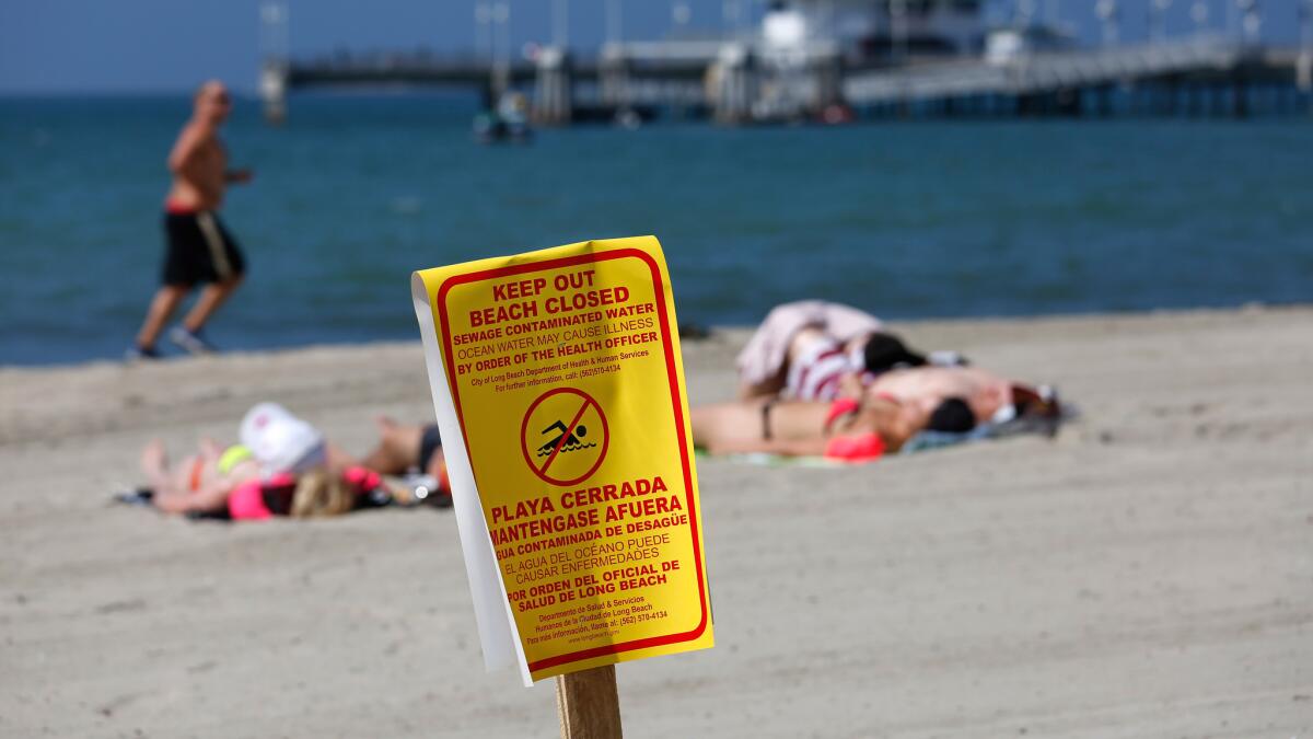 A sewage spill in Boyle Heights flowed into the L.A. River on Monday, prompting officials to shut down beaches in Long Beach.