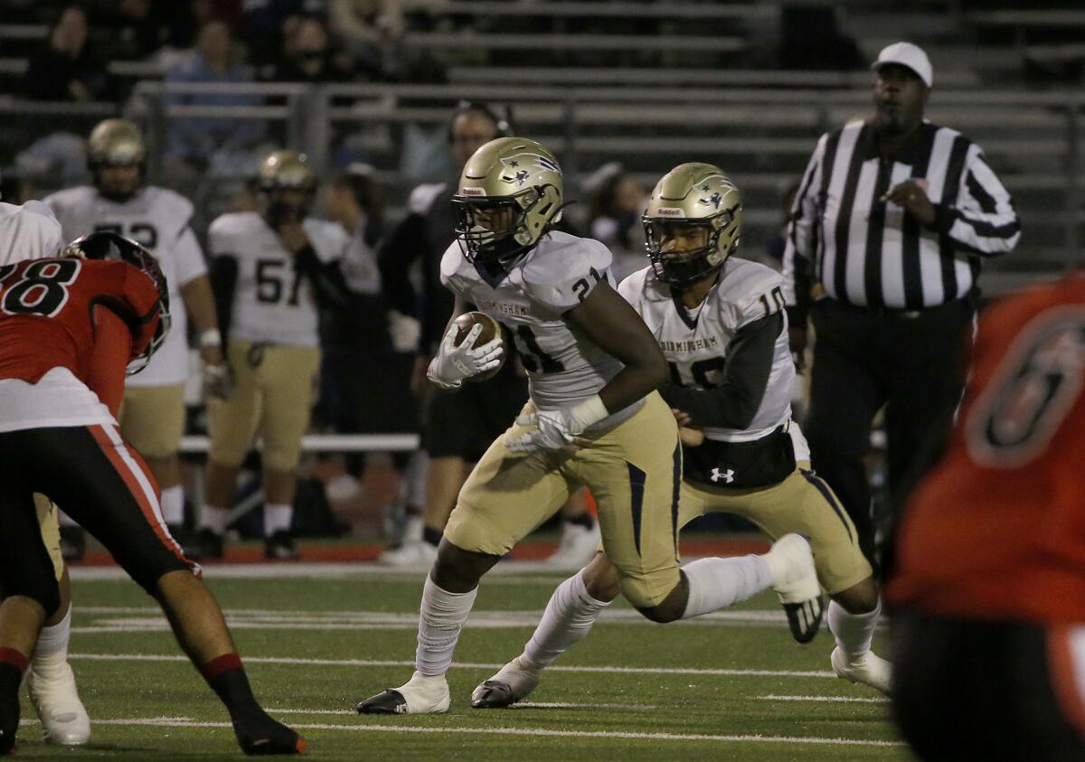 Birmingham running back Ronnell Hewitt takes a handoff from quarterback Kingston Tisdell.