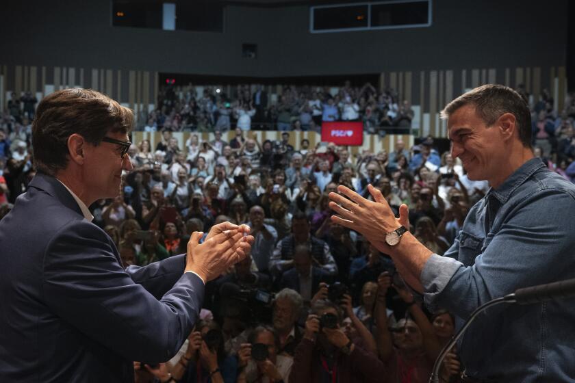 Spanish Prime Minister Pedro Sánchez applauds the socialist candidate, Salvador Illa, left, during a campaign rally in Villanova i la Gertru, near Barcelona, Spain, Thursday, May 9, 2024. Some nearly 6 million Catalans are called to cast ballots in regional elections on Sunday that will surely have reverberations in Spain's national politics. (AP Photo/Emilio Morenatti)