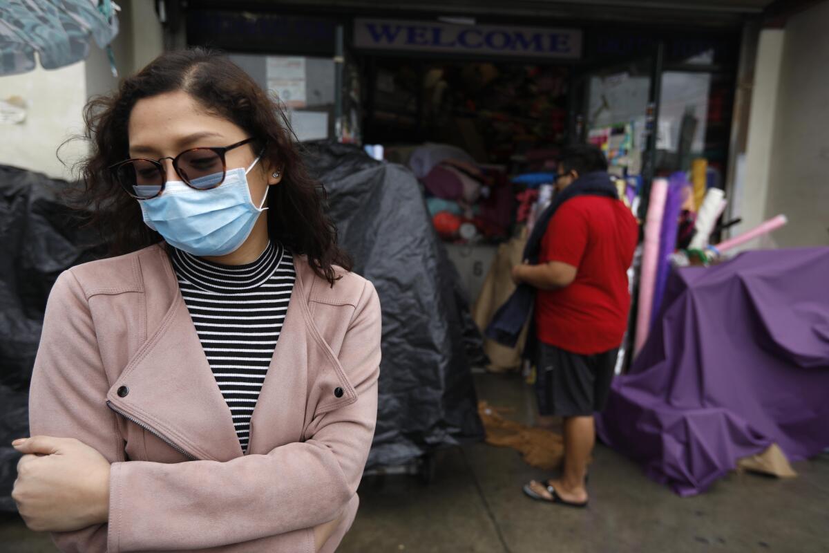 Charm Resuello, 26, wears a surgical mask while shopping in downtown Los Angeles.