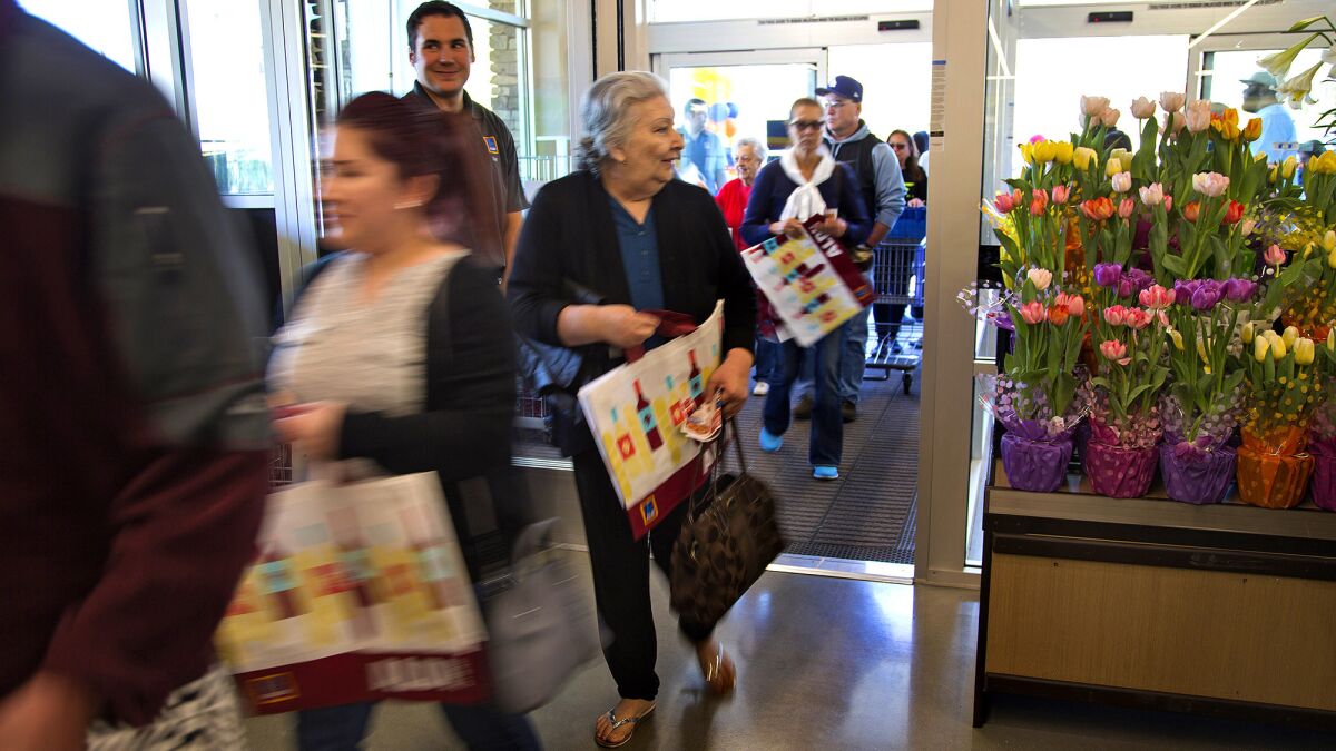 Early shoppers enter Aldi food market in Moreno Valley during the grand opening on Thursday.