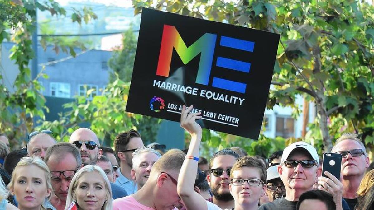 People gather at a rally in West Hollywood last year to celebrate the U.S. Supreme Court decision legalizing same-sex marriage.