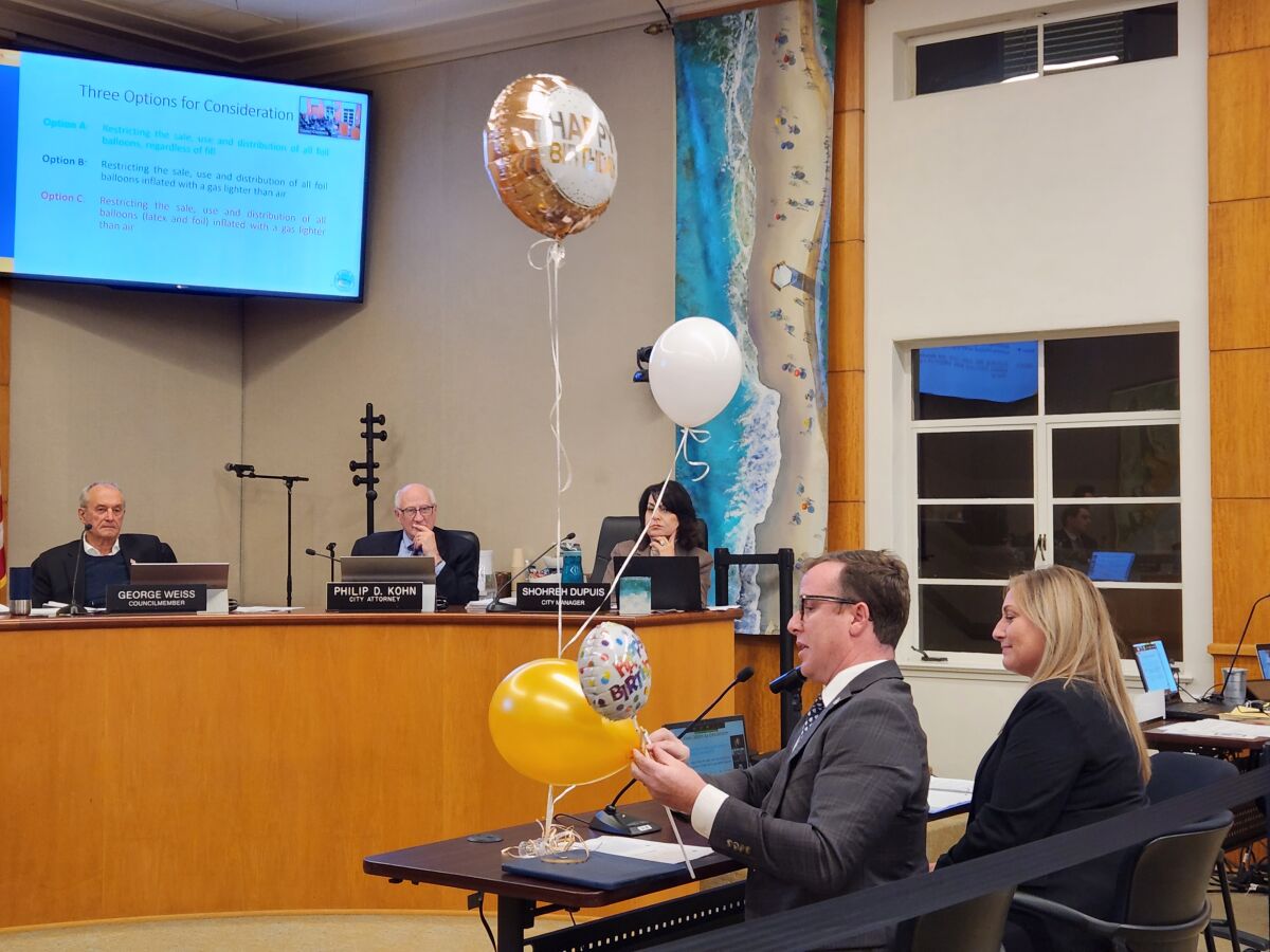 Jeremy Frimond, assistant to the city manager, demonstrates different types of balloons to the Laguna Beach City Council.