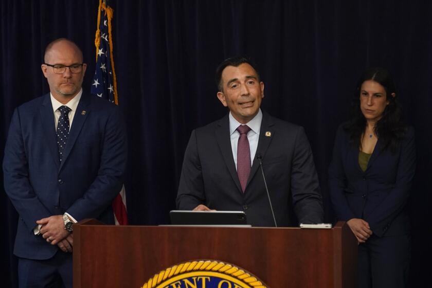 U.S. Attorney Martin Estrada, center, speaks during a news conference Thursday, April 11, 2024, in Los Angeles. The former longtime interpreter for Los Angeles Dodgers star Shohei Ohtani is being charged with federal bank fraud for crimes involving gambling debts and theft of millions of dollars from the Japanese sensation, federal authorities said Thursday. U.S. Attorney Martin Estrada announced the charges Thursday. (AP Photo/Ryan Sun)