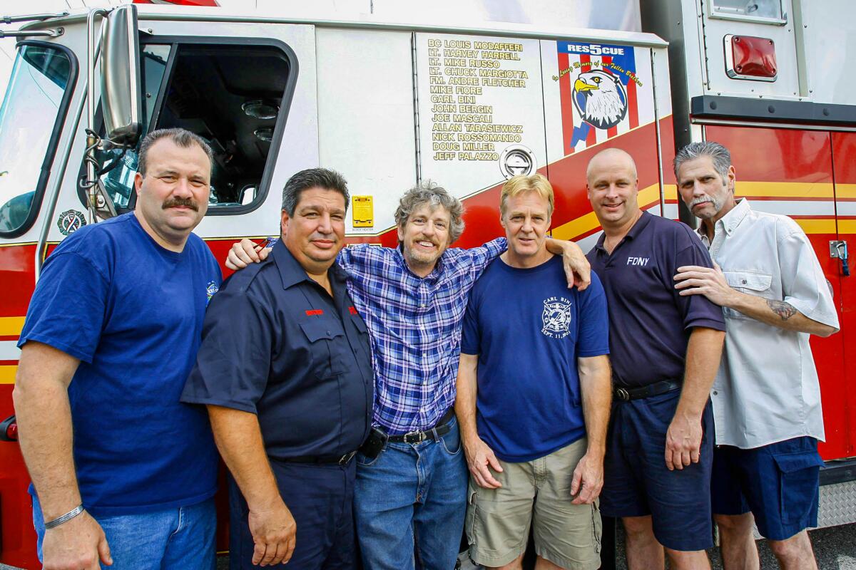 July 2011: L.A. Times staff photographer Gary Friedman with five of the six members of Rescue 5 who were working at the firehouse on Sept. 11, 2001. Tony Cavaleri, left, Joey Esposito Friedman, Tom Inhken and Larry Sullivan. Not pictured is Frank Hauber. The names of the Rescue 5 members who died are painted on the rig in this July 2011 photo.