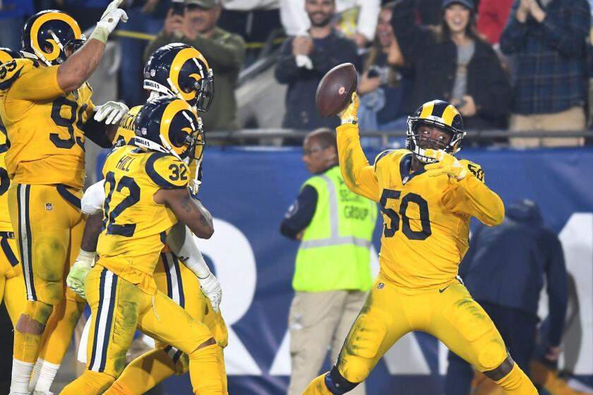 LOS ANGELES, CALIFORNIA NOVEMBER 19, 2018-Rams linebacker Samson Ebukam spikes the ball after intercepting a pass for a touchdown againt the Chiefs inthe 3rd quarter at the Coliseum Monday. (Wally Skalij/Los Angeles Times)