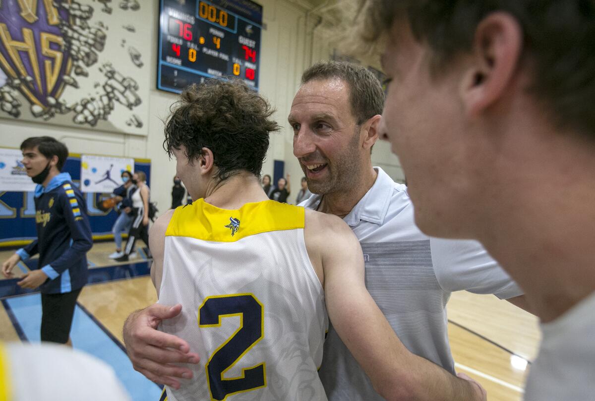 Marina's head coach Nick Racklin hugs Eric Hodgkins after beating Los Angeles Shalhevet on Thursday.