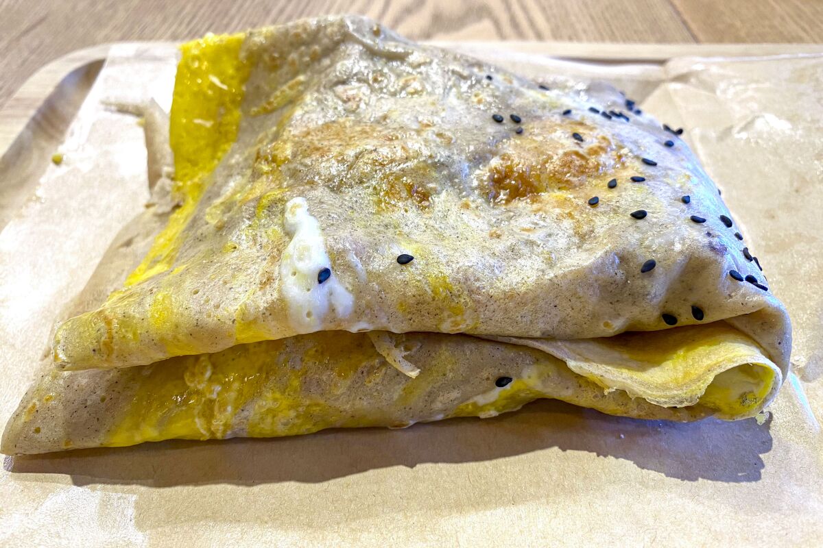 Jian bing from Me + Crepe, a stuffed crepe dotted with sesame seeds