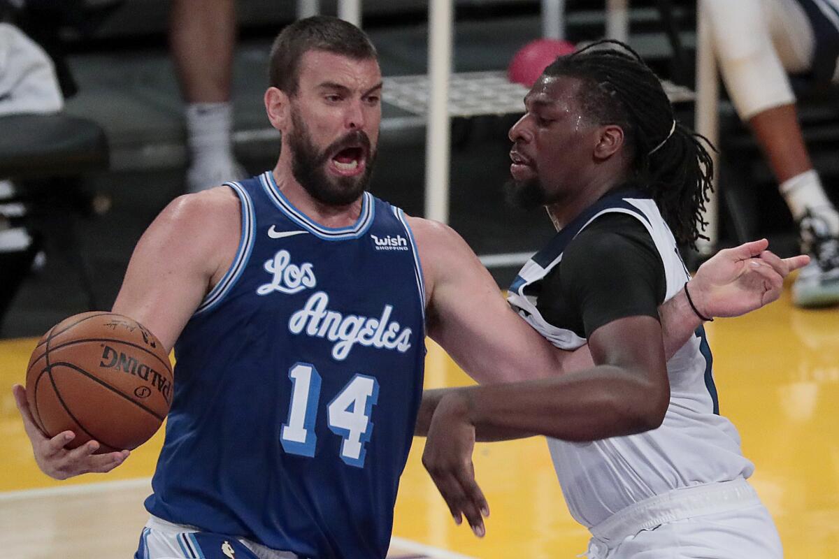 Lakers center Marc Gasol drives on Minnesota Timberwolves center Naz Reid.