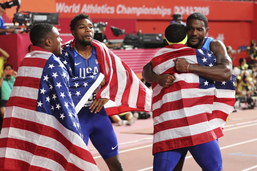 Gold medalists in the 4x100 relay, of the United States, celebrate at the World Athletics Championships in Doha, Qatar, Saturday, Oct. 5, 2019. (AP Photo/Hassan Ammar)