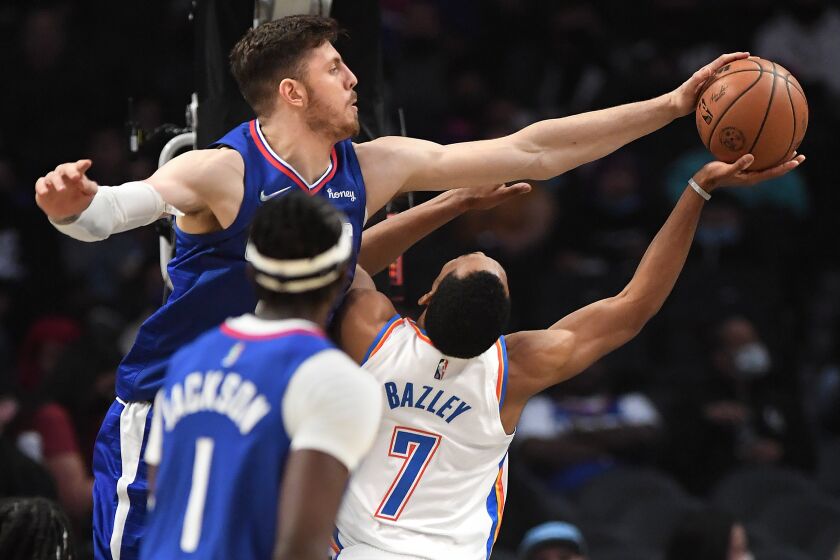 Los Angeles, California November 1, 2021: Clippers Isaiah Hartenstein blocks the shot of Thunders Darius Bazley but a foul is committed by Clippers Terance Mann (not pictured) in the first quarter at the Staples Center Monday. (Wally Skalij/Los Angeles Times)