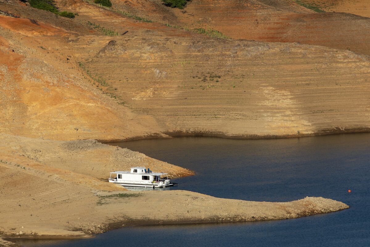 A houseboat is beached at depleted Lake Shasta.