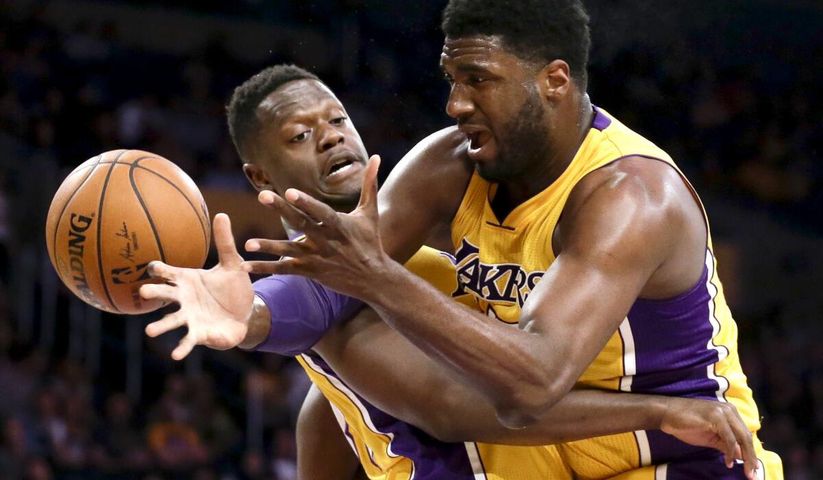 Lakers center Roy Hibbert, right, and forward Julius Randle scramble for a rebound against the Suns during the first half Friday.