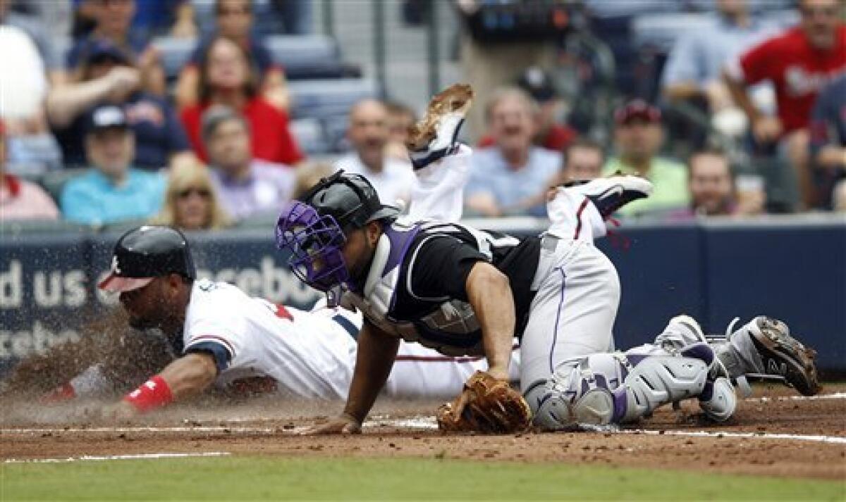 Atlanta Braves' Brian Jordan throws the ball toward the infield