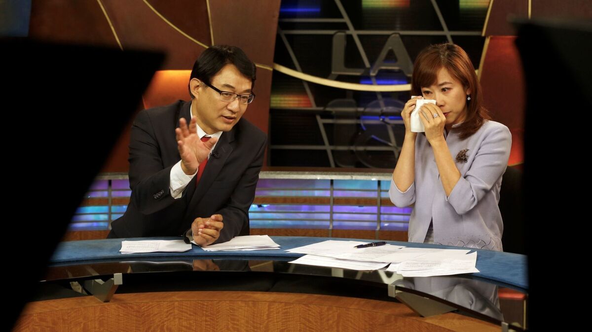 Channel 18 news anchors Harry Chang and Christine Chiang, right, lead their final KSCI-TV broadcast Friday in Los Angeles.