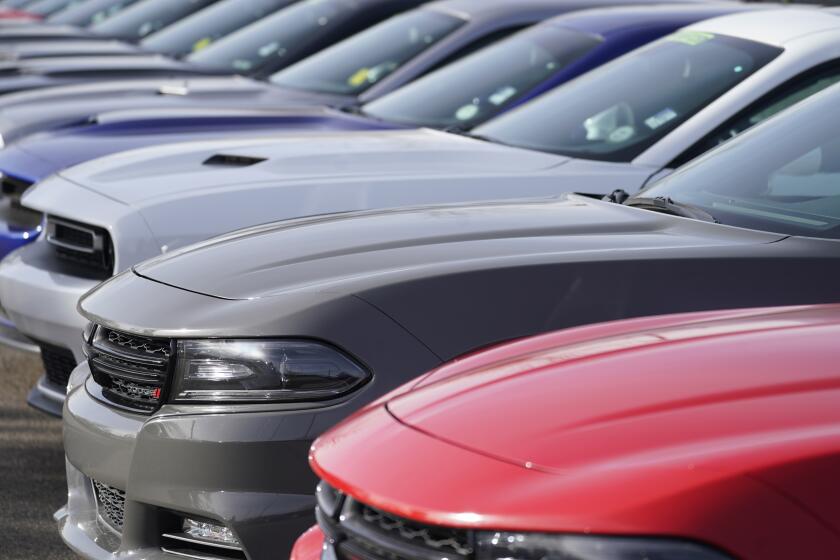 A long row of used Dodge models sits at a Dodge dealership Sunday, Dec. 27, 2020, in Littleton, Colo. (AP Photo/David Zalubowski)