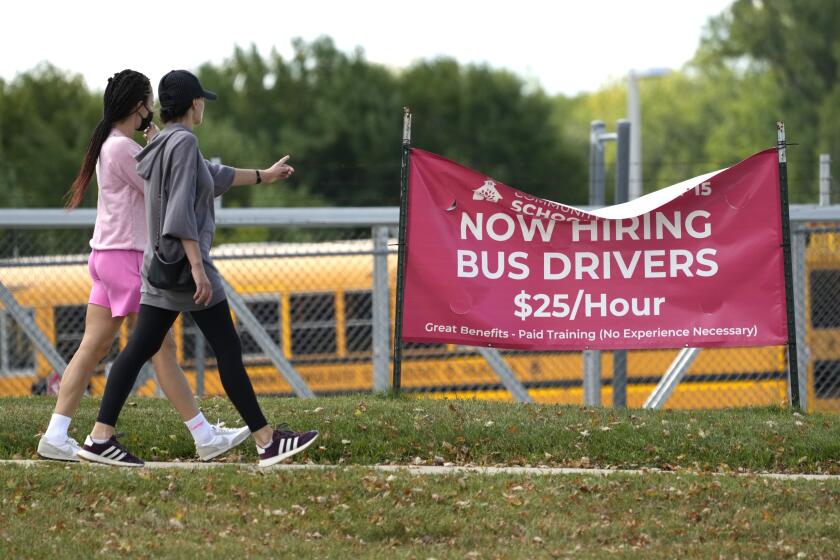 A sign advertising jobs for bus drivers is posted in Palatine, Ill., Wednesday, Sept. 13, 2023. On Thursday, the Labor Department reports on the number of people who applied for unemployment benefits last week. (AP Photo/Nam Y. Huh)
