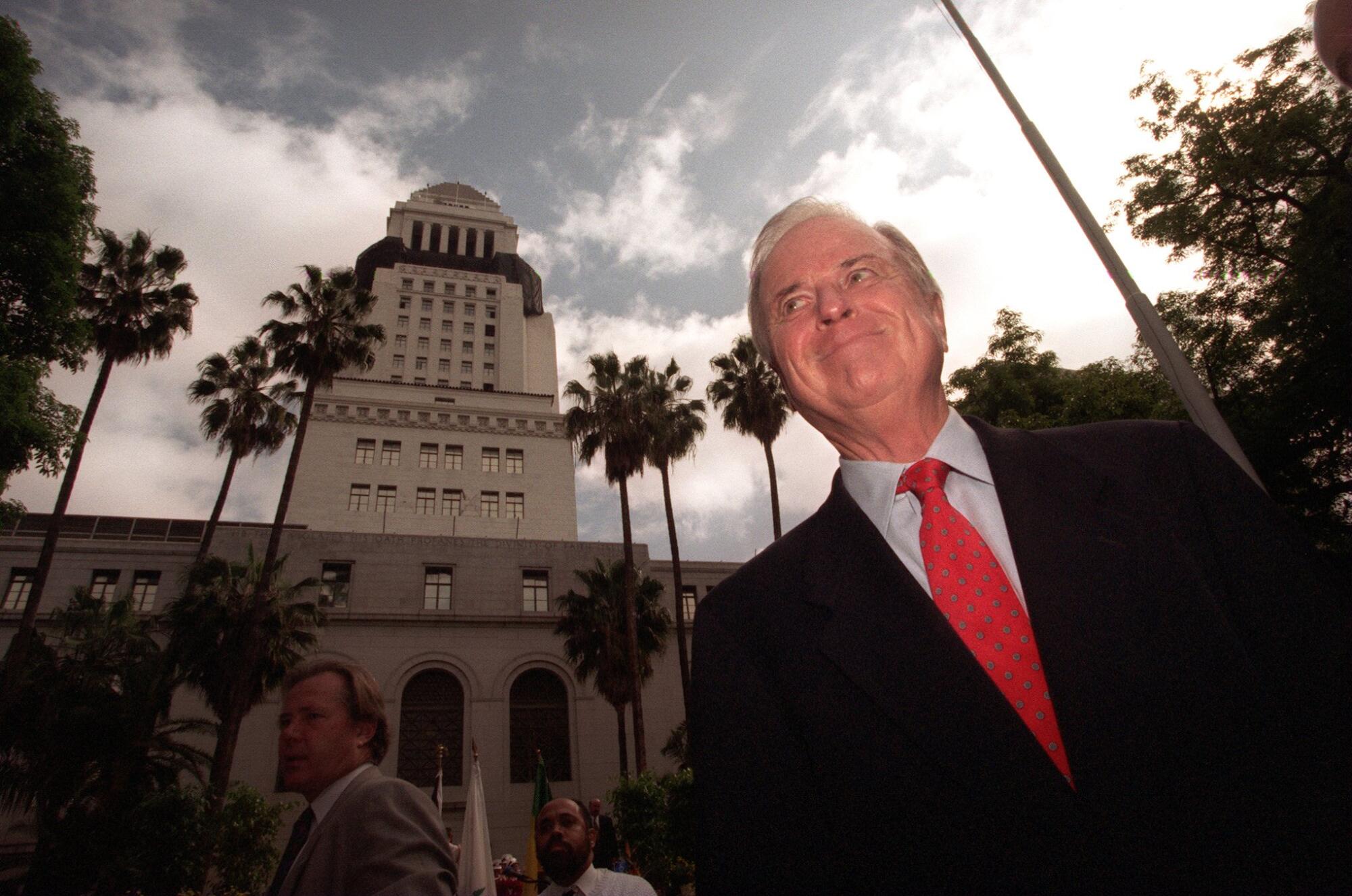 Los Angeles Mayor Richard Riordan poses with City Hall in the background.