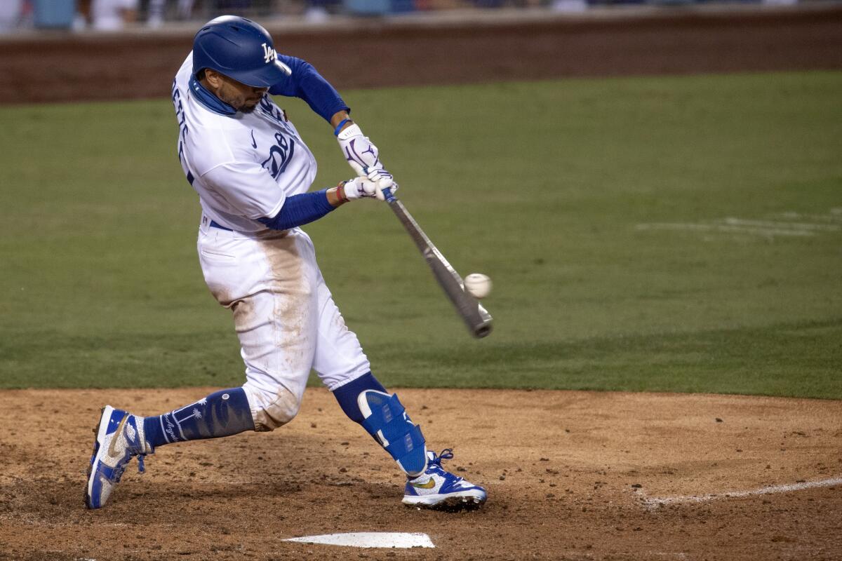 Dodgers right fielder Mookie Betts hits a two-run home run during the eighth inning.