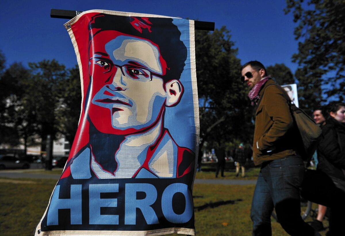 At a protest against government surveillance in Washington in October, a poster of Edward Snowden declares him a hero.