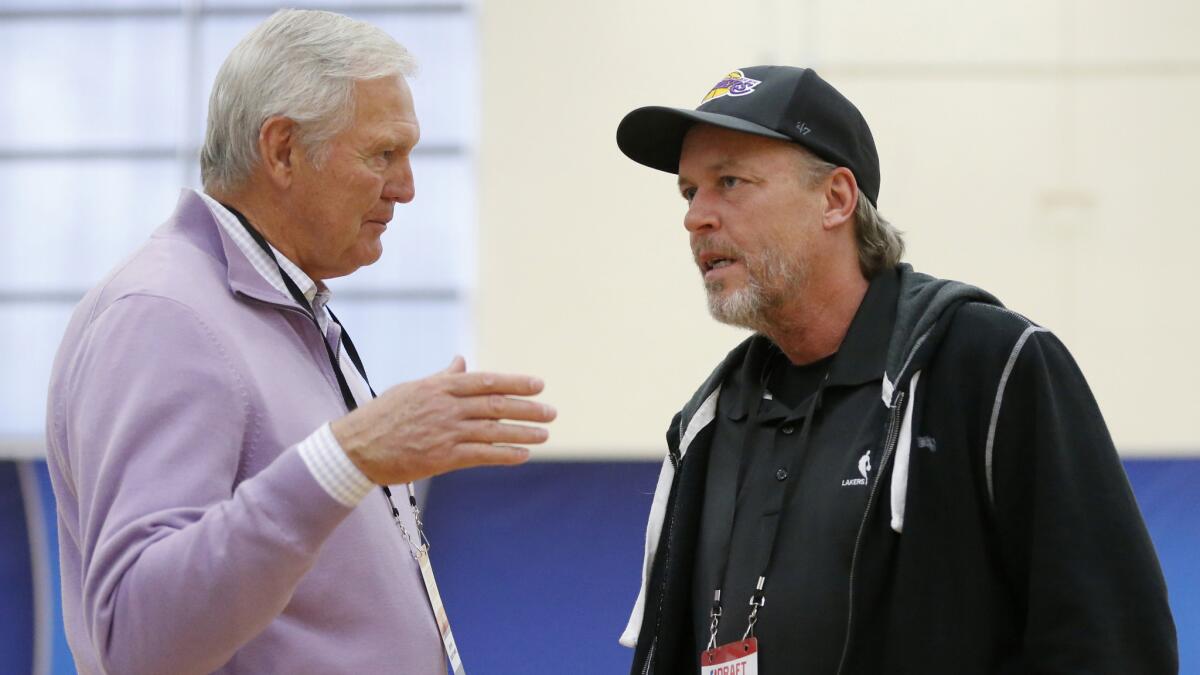 Jim Buss, part-owner and executive vice president of basketball operations of the Lakers, speaks with Lakers great Jerry West, left, during the NBA draft combine in Chicago.