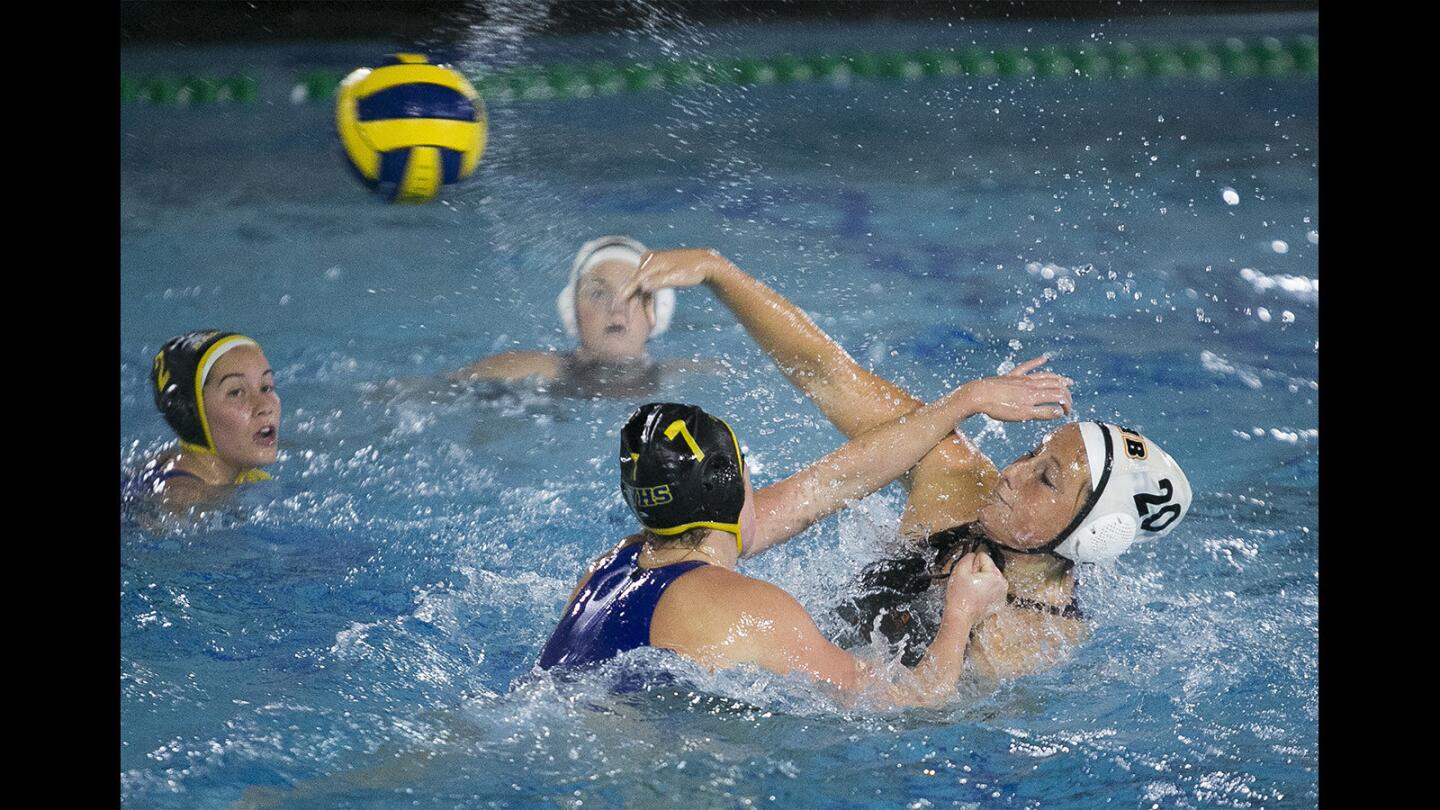 Huntington Beach's Madeline Bockman takes a shot under pressure from Fountain Valley's Grace Galleher in a Sunset League game on Wednesday, January 10.