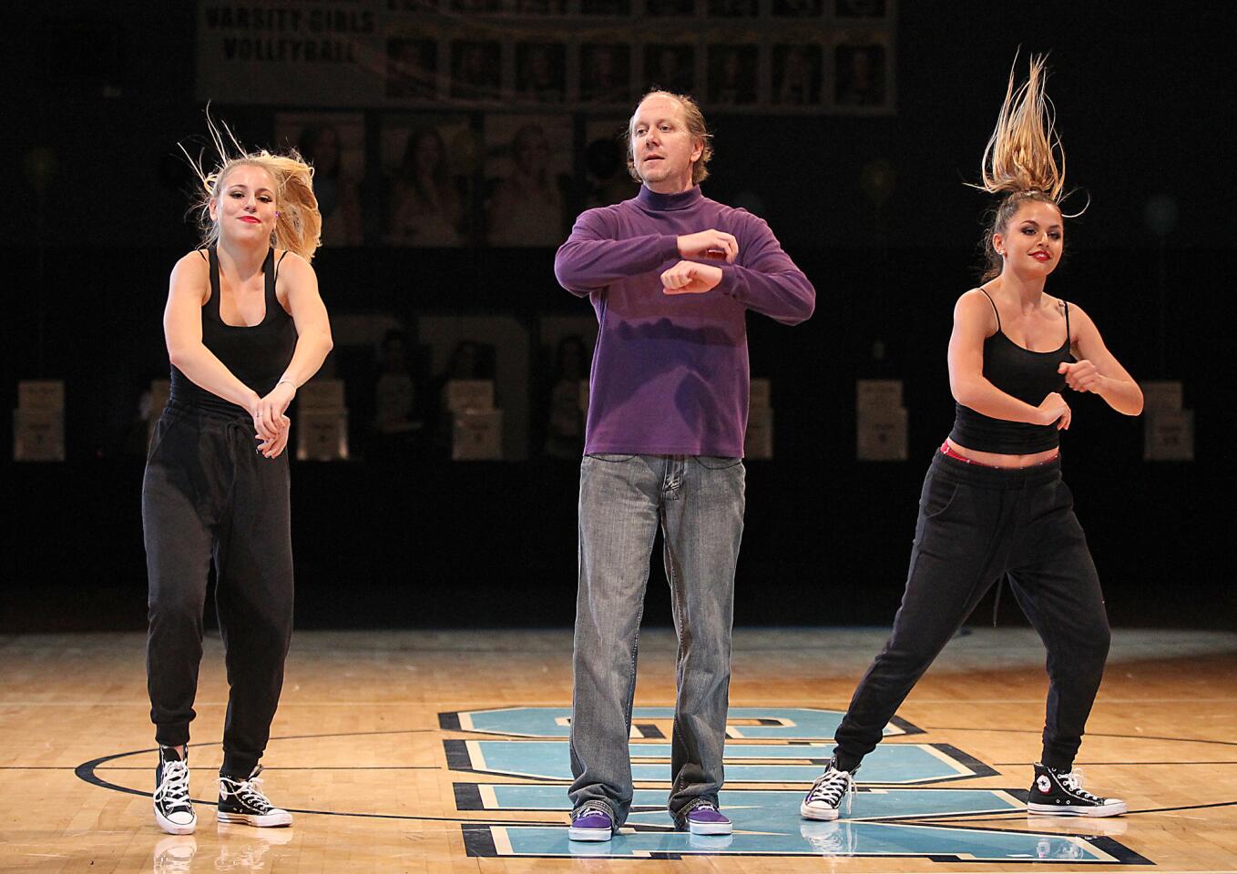 Teacher Daniel Leedy gets into the act to a hip-hop routine with students Sophie Axelson and Ava Antoyan during the Corona del Mar High fourth annual Dancing with the Teachers performance on Thursday in the school gym.