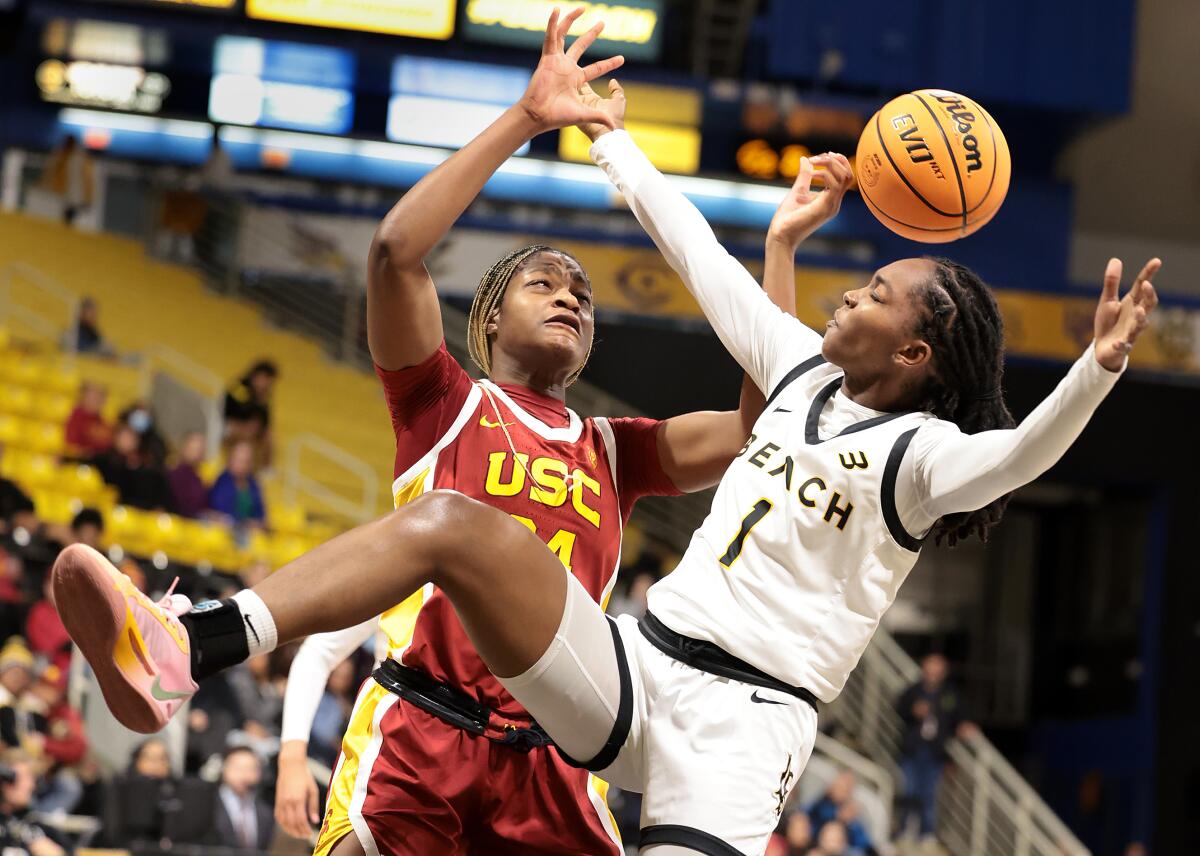 Clarice Akunwafo battles for a rebound with Lovely Sonnier in the fourth quarter.