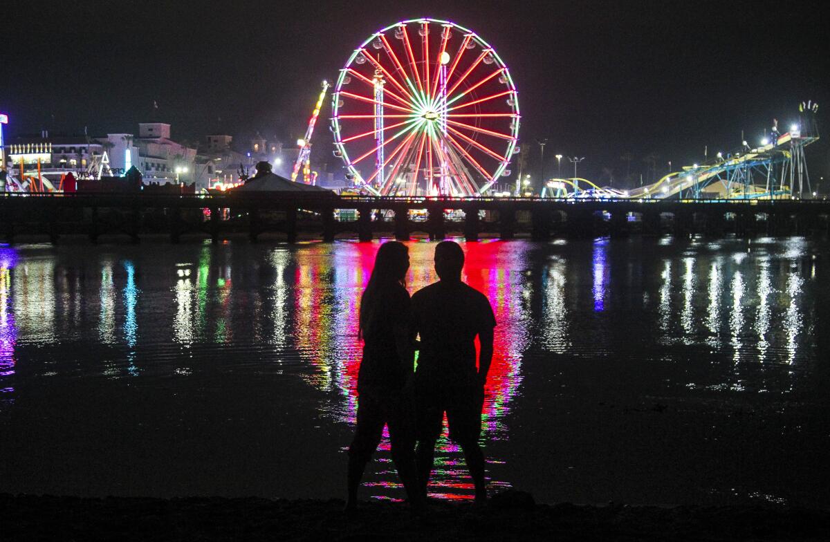 Samantha Sloss and Antonio Robles watch the lights of the San Diego County Fair in 2019.