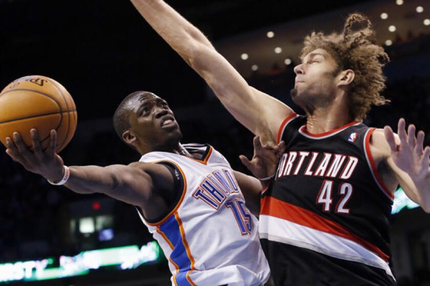Oklahoma City Thunder guard Reggie Jackson, left, puts up a shot in front of Portland Trail Blazers center Robin Lopez during a game on Jan. 21. The two teams meet again Tuesday in a Western Conference showdown.