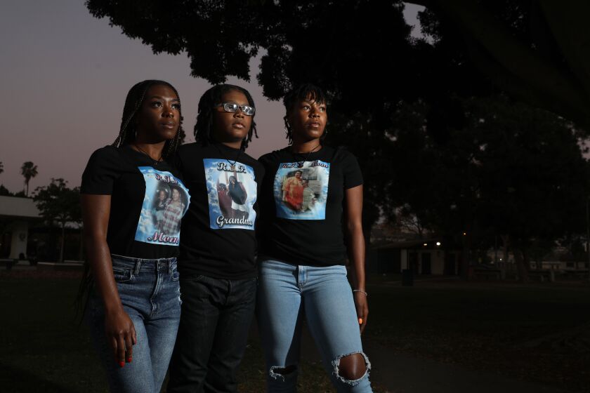 LONG BEACH, CA - DECEMBER 10: Kenniya Fairley, 27, daughter, DeAngelo Johnson Jr., 11, grandson, and Faneka Williams, 32, daughter, of Carla Walton, deceased, at Martin Luther King Jr. Park on Thursday, Dec. 10, 2020 in Long Beach, CA. Carla Walton, 48, died after being shot while attending a candlelight vigil for a childhood friend in North Long Beach. One week of homicides, June 29 to July 5, the deadliest of the year. Thirty people were killed in Los Angeles County that week. (Gary Coronado / Los Angeles Times)