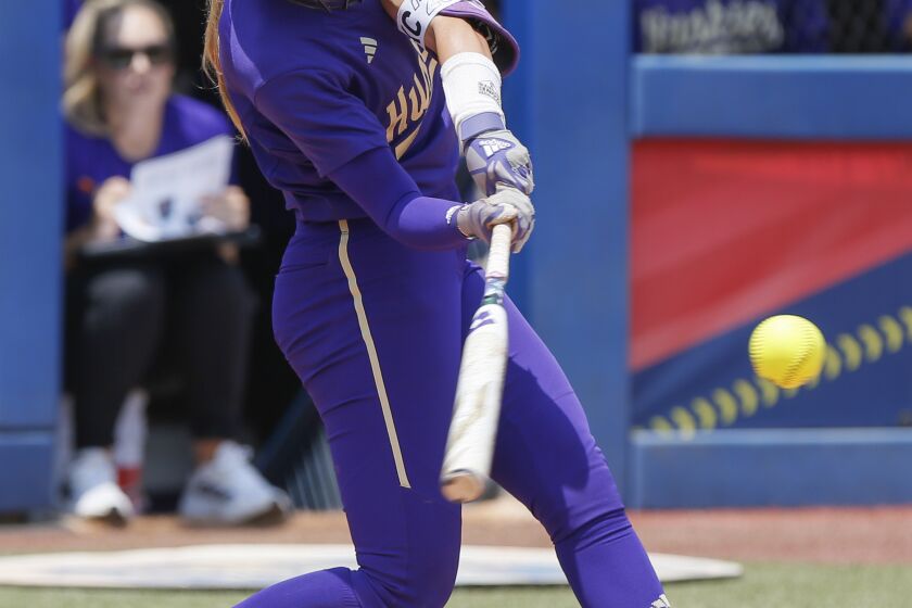Washington's Rylee Holtorf hits a home run against Utah during the second inning of an NCAA softball Women's College World Series game Friday, June 2, 2023, in Oklahoma City. (AP Photo/Nate Billings)