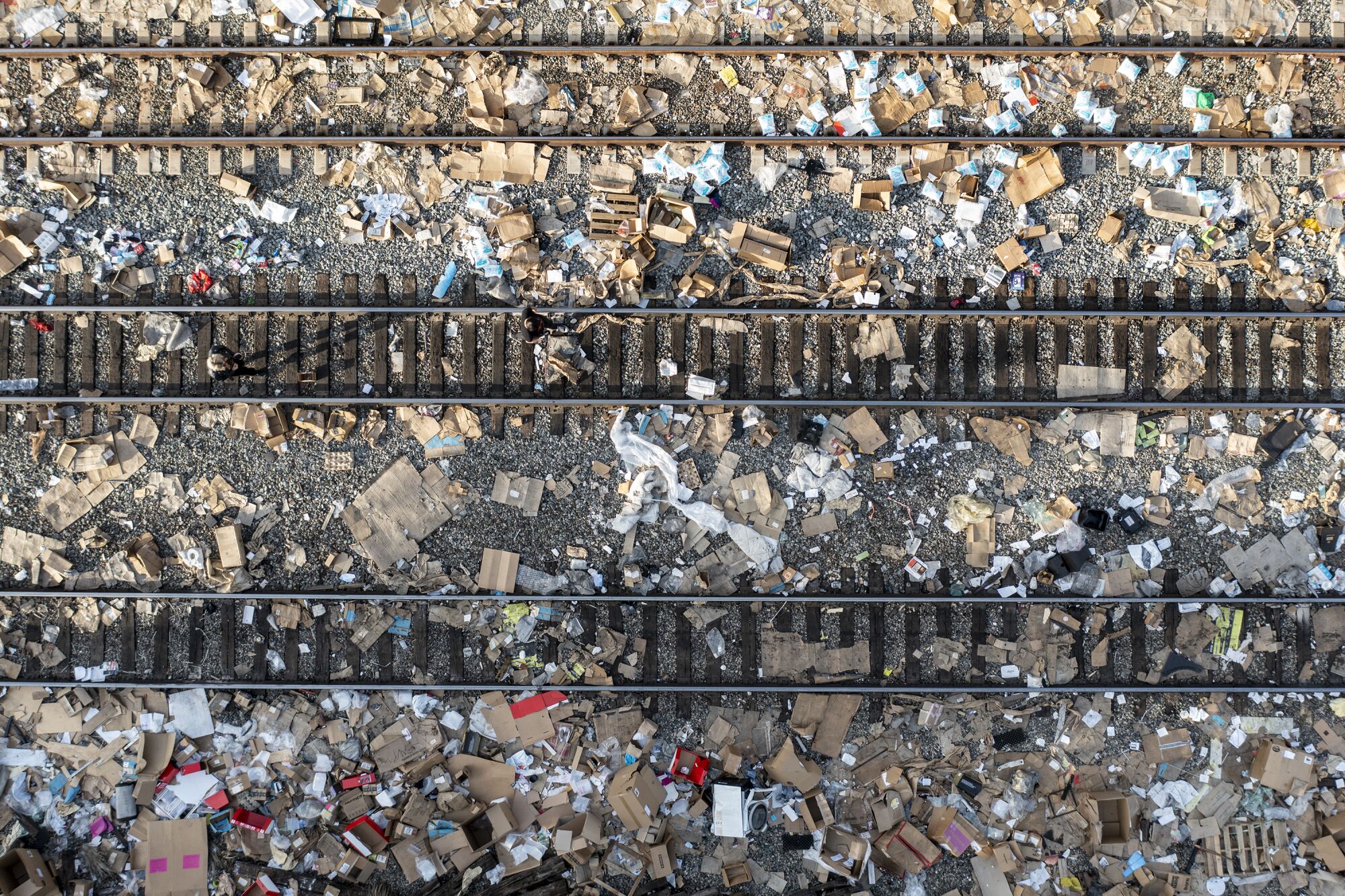 Debris from shredded packages is strewn across railroad tracks passing through Lincoln Heights. 